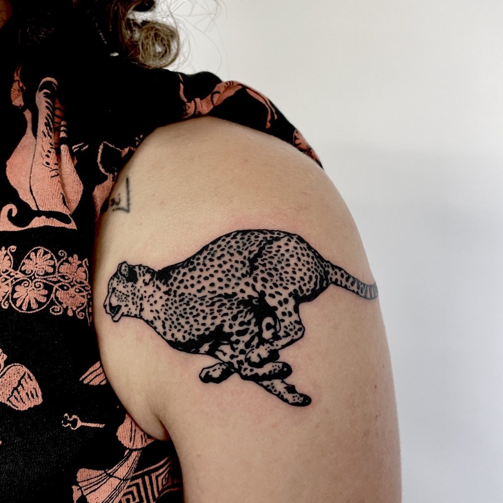 Black running cheetah tattoo