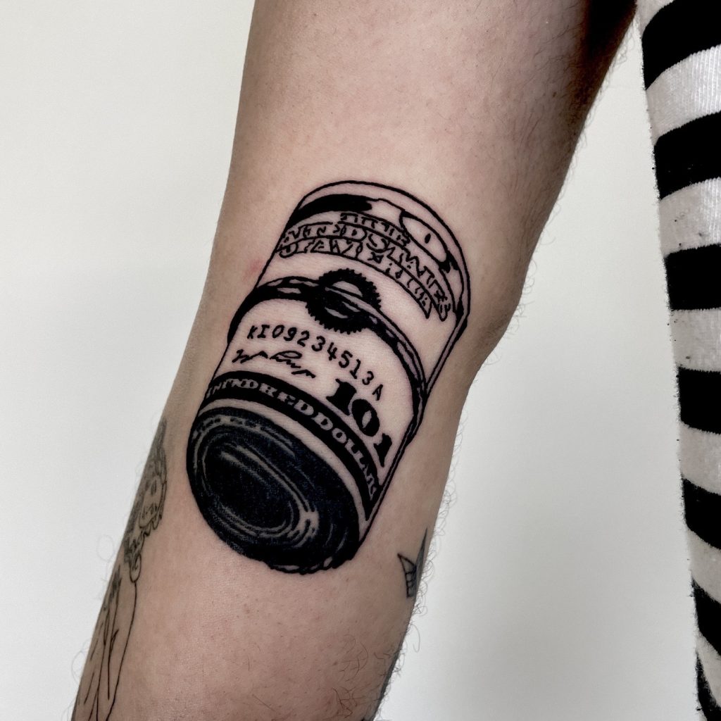 Black roll of dollars tattoo