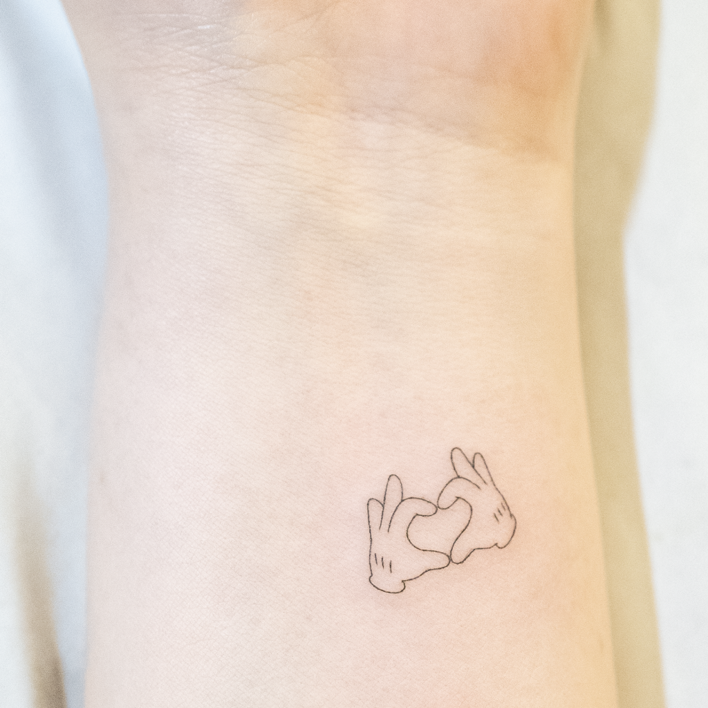 Mickey mouse hand heart tattoo