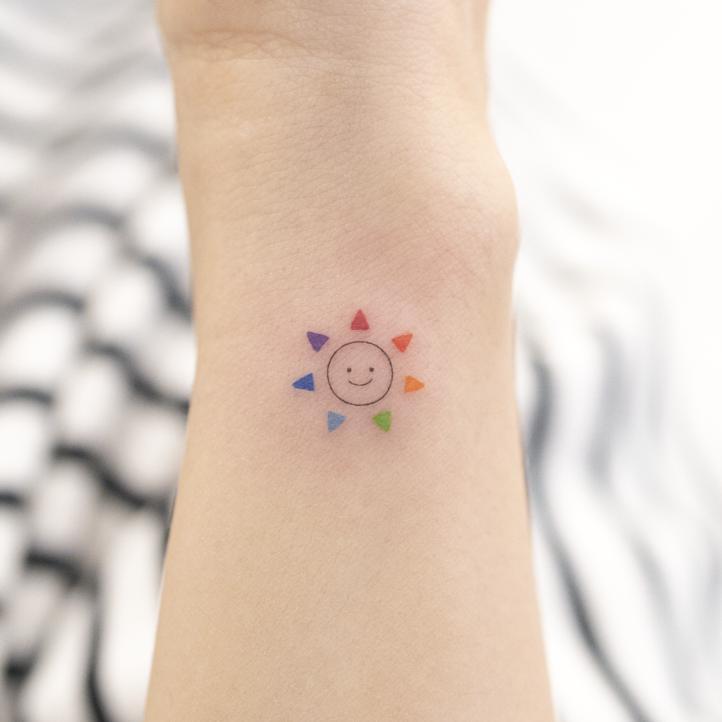 Smiley sun tattoo