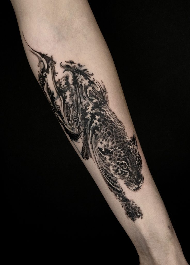 blackwork abstract leopard tattoo on arm