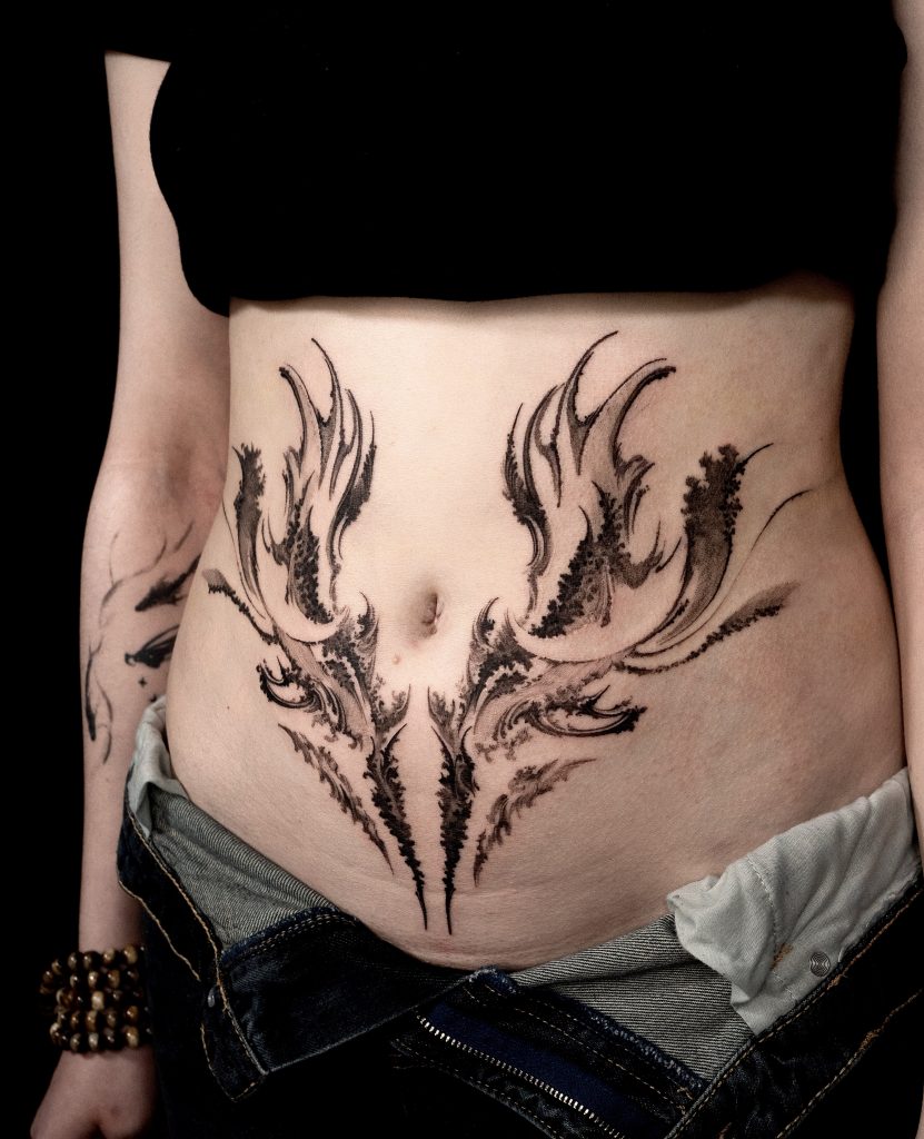 Blackwork stomach tattoo